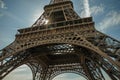 Bottom view of Eiffel Tower made in iron and Art Nouveau style, with sunny blue sky in Paris. Royalty Free Stock Photo